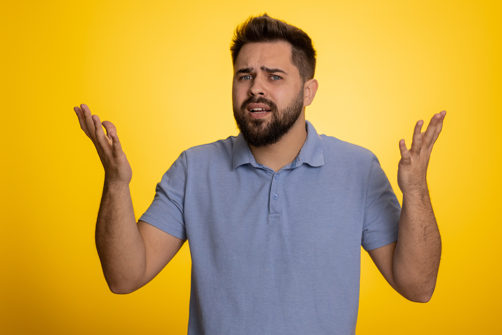 Man raising hands in indignant expression ask why what reason of failure demonstrating disbelief